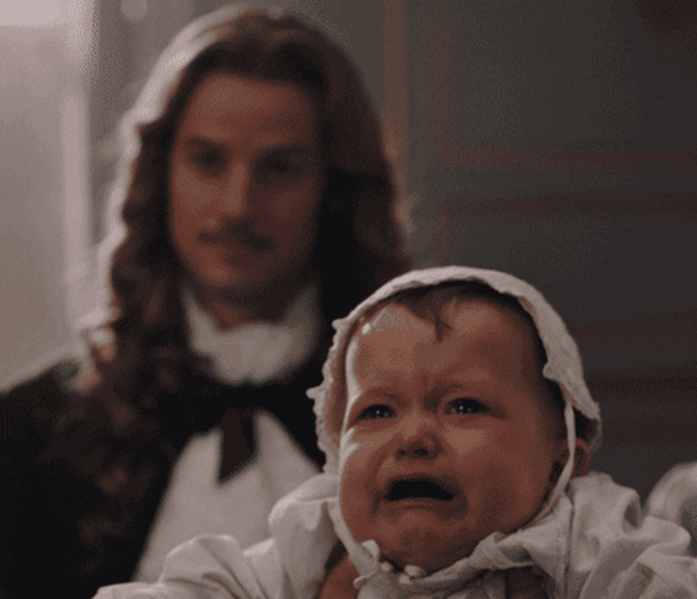 gif of character in historical costume holding a crying baby saying make it stop