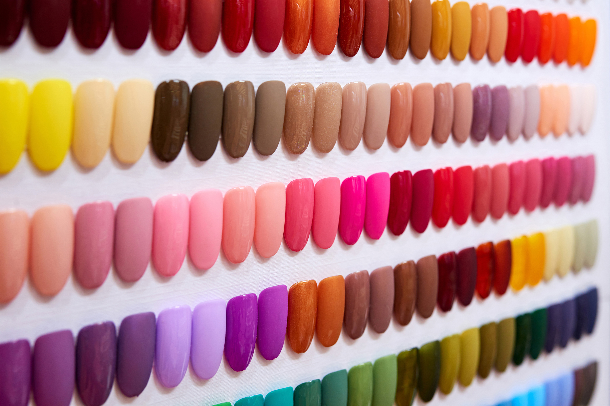 Rows of various colored nail polish samples for selection at a wedding salon