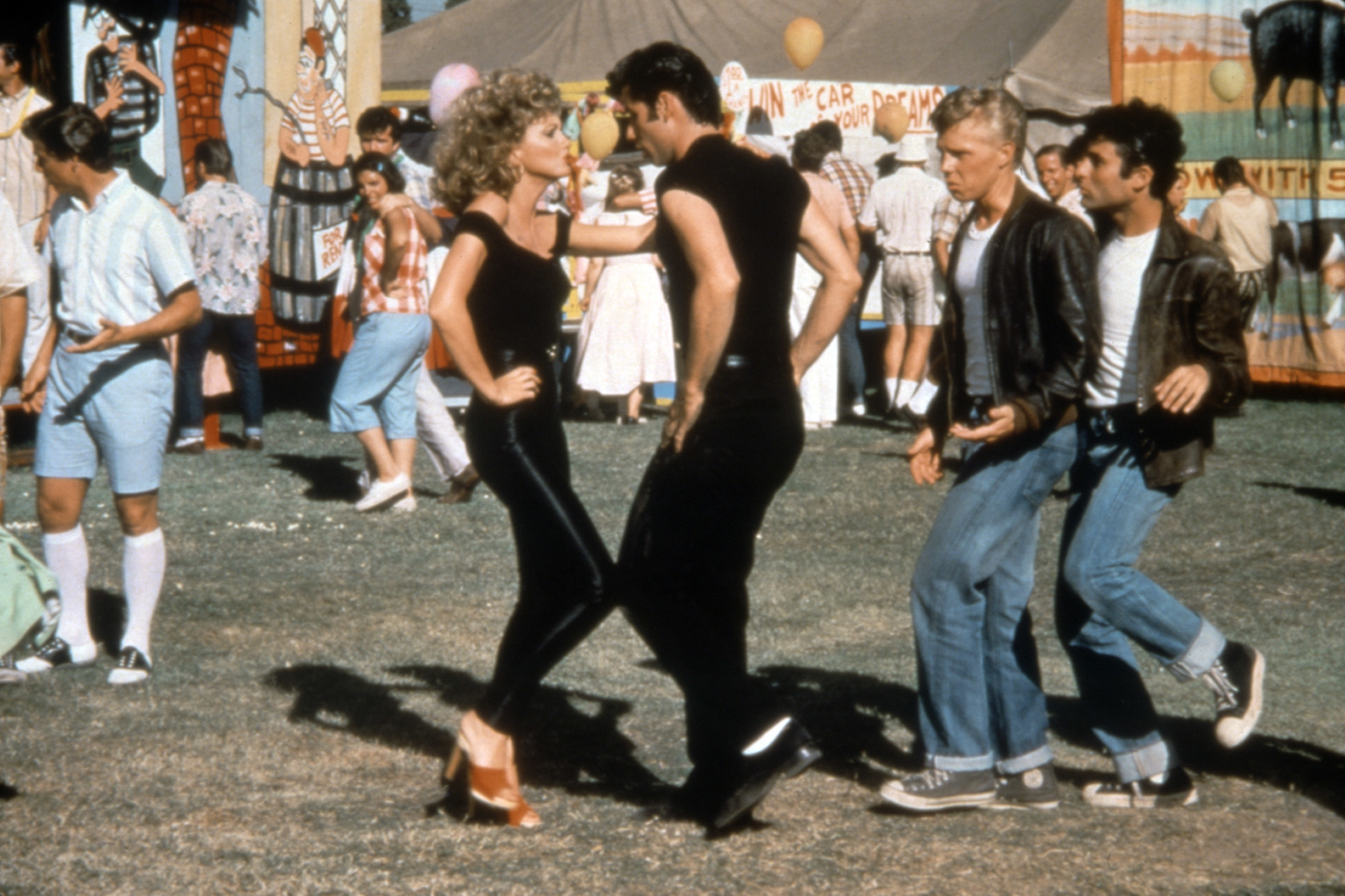 Danny and Sandy from Grease in a dance pose at the carnival