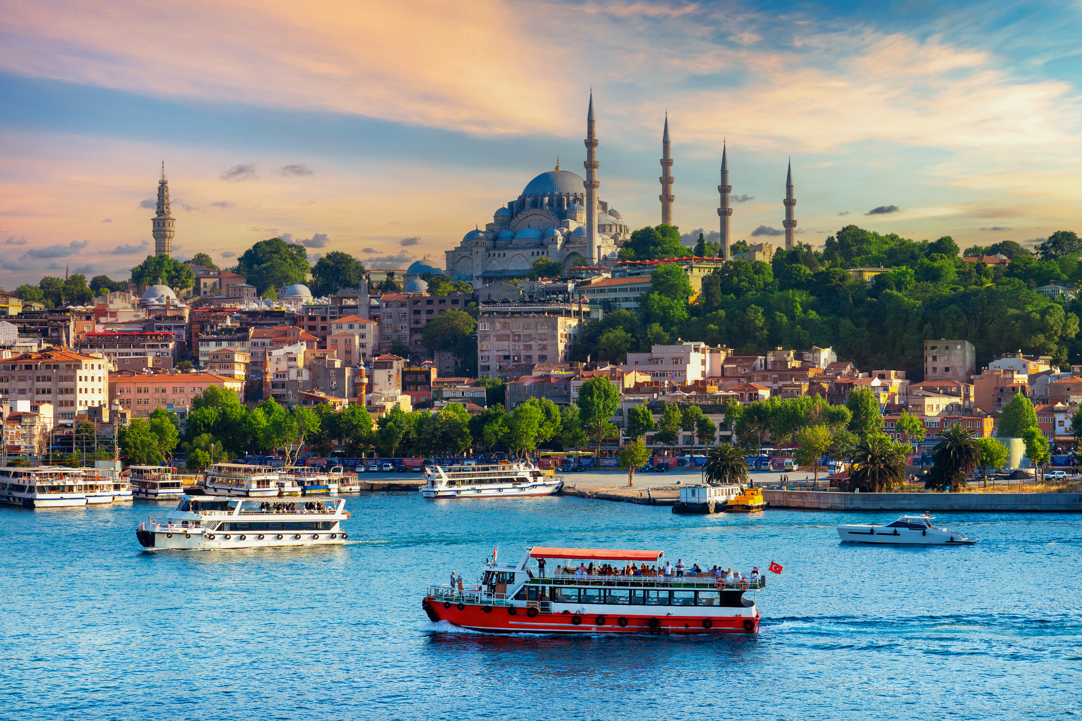 Skyline of Istanbul with iconic Suleymaniye Mosque and bustling waterway with boats