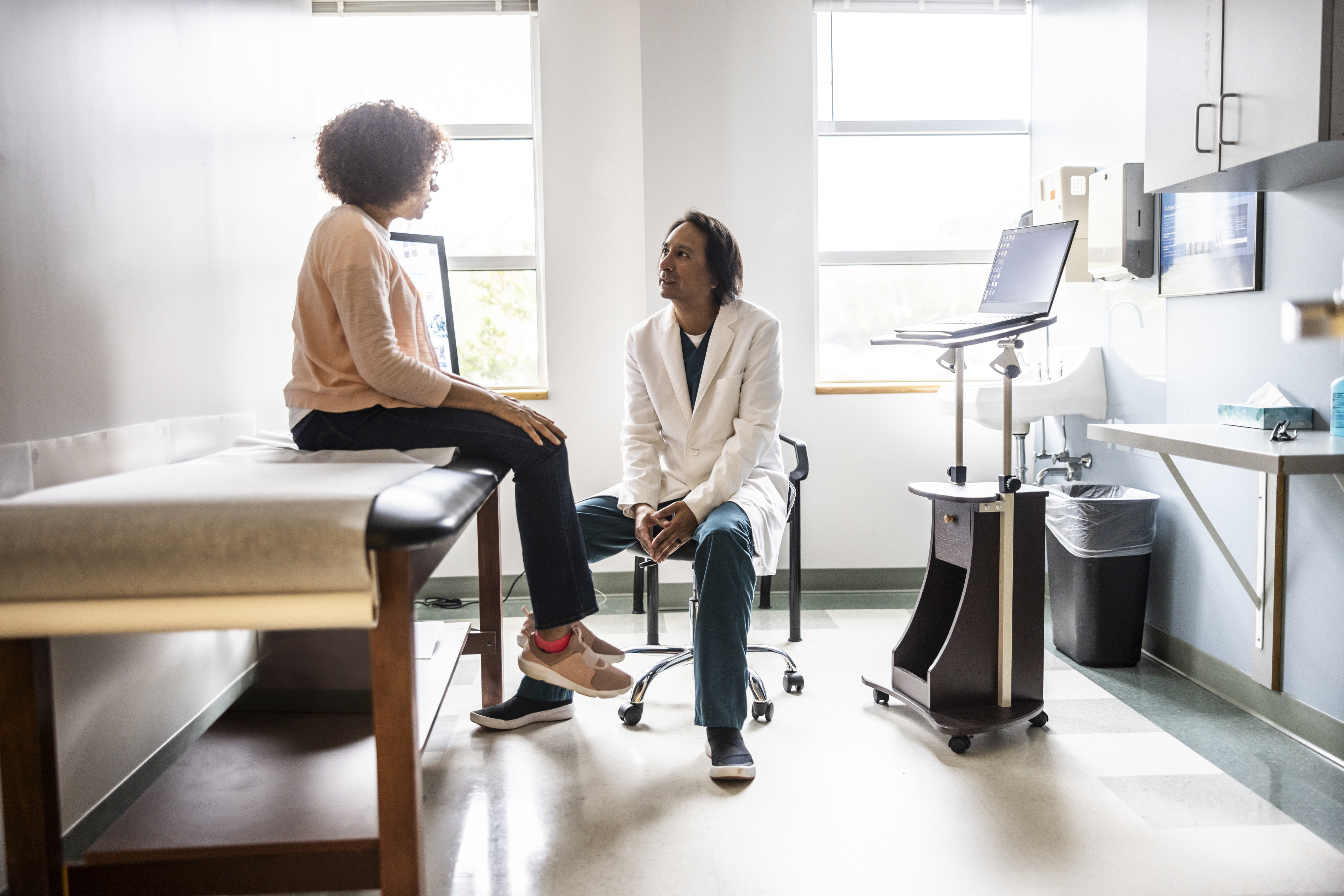 Patient having a conversation with a healthcare provider in a medical office