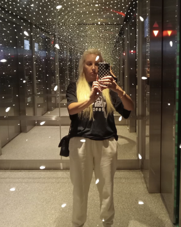 Amanda taking a selfie in a mirror with starlike light reflections around her