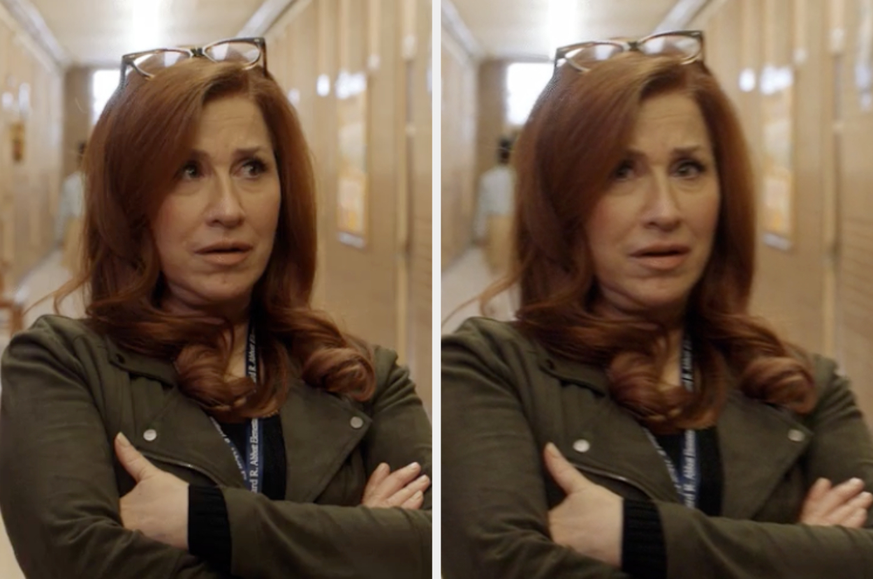 Woman in a hallway looking concerned with arms crossed