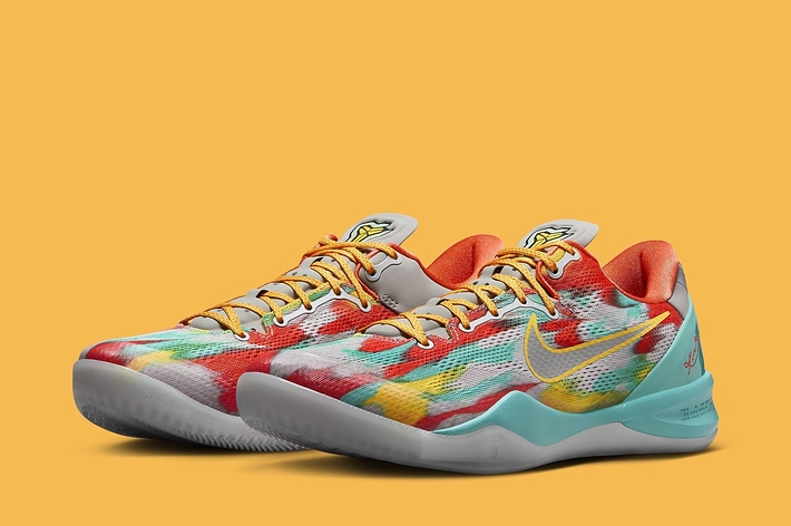 A pair of vibrant, patterned sneakers on a solid background