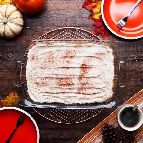 A freshly baked cinnamon roll casserole on a festive autumn-themed table setting