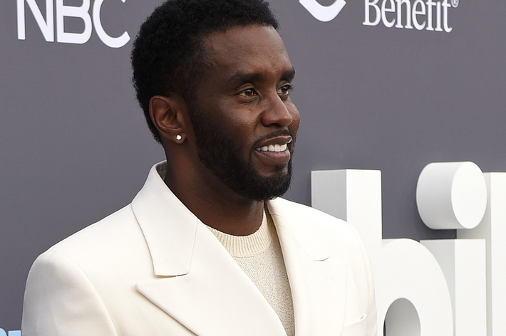 Sean Combs in a white suit at an event