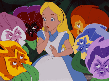 Alice surrounded by animated flowers in Alice in Wonderland