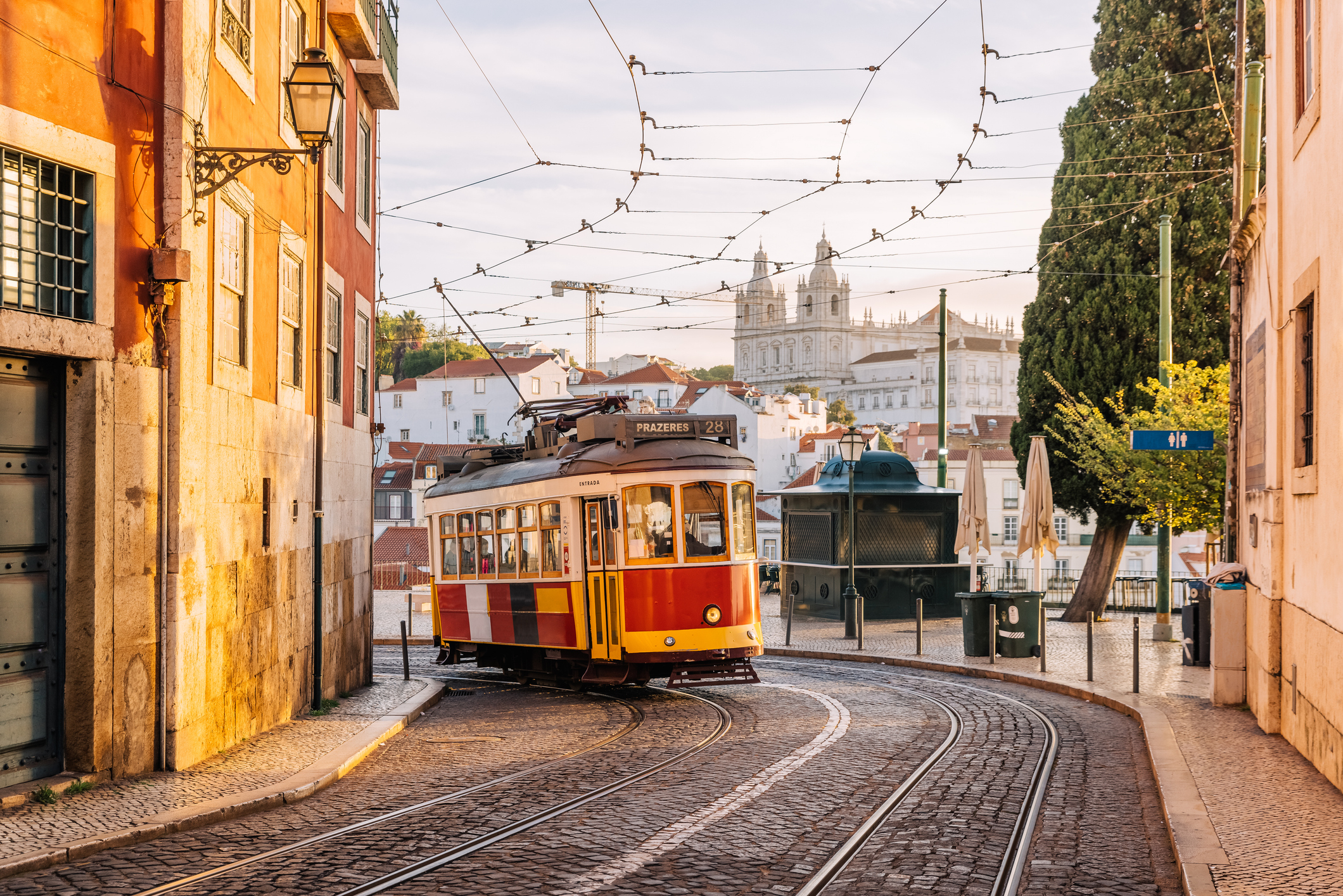 Historic tram on a street in Lisbon with buildings in the background, capturing the essence of local transport in the city