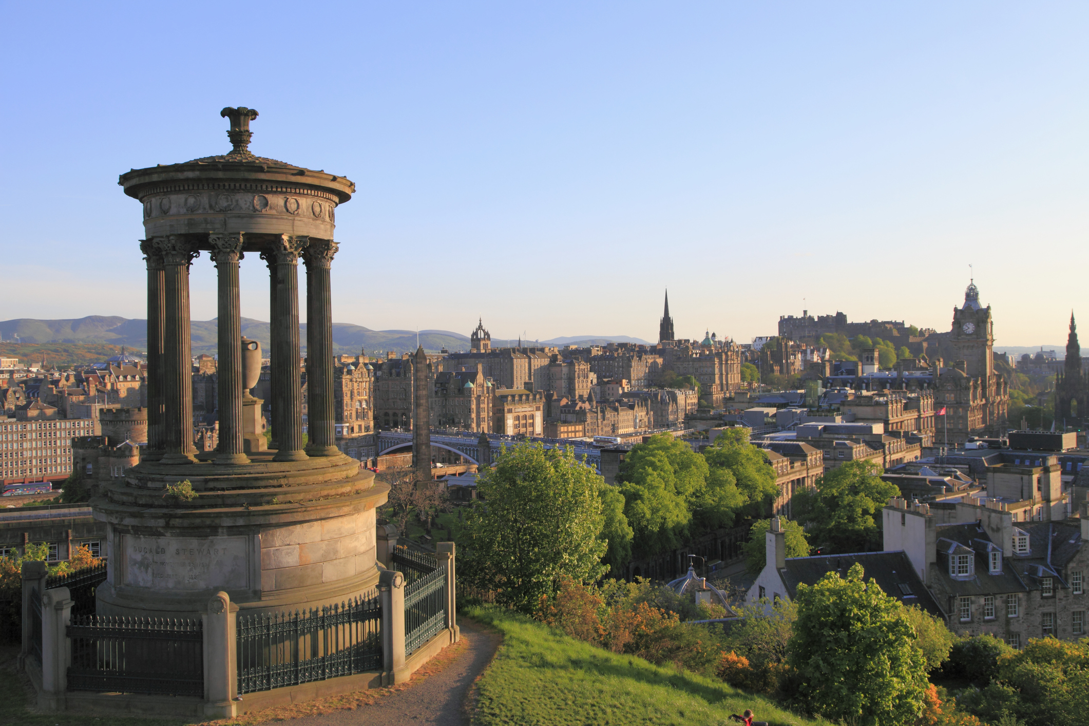 A panoramic view of Edinburgh with the Dugald Stewart Monument in the foreground