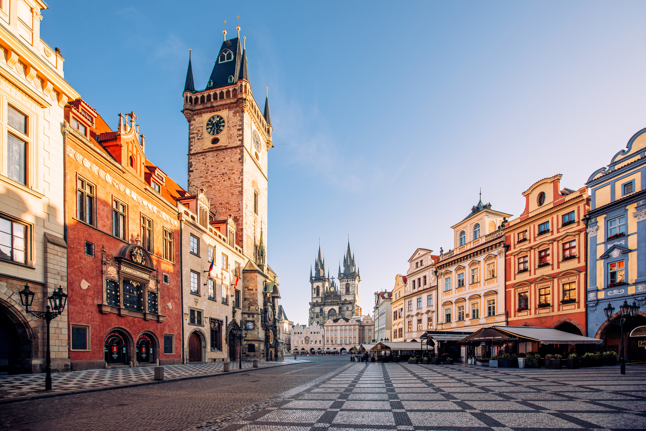 Old Town Square with historical buildings and clock tower in Prague, clear day
