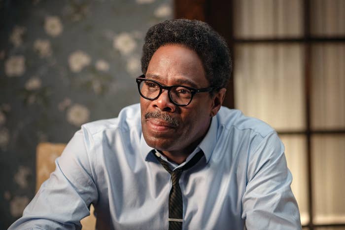 Colman Domingo as Bayard Rustin in business attire with glasses looking pensive