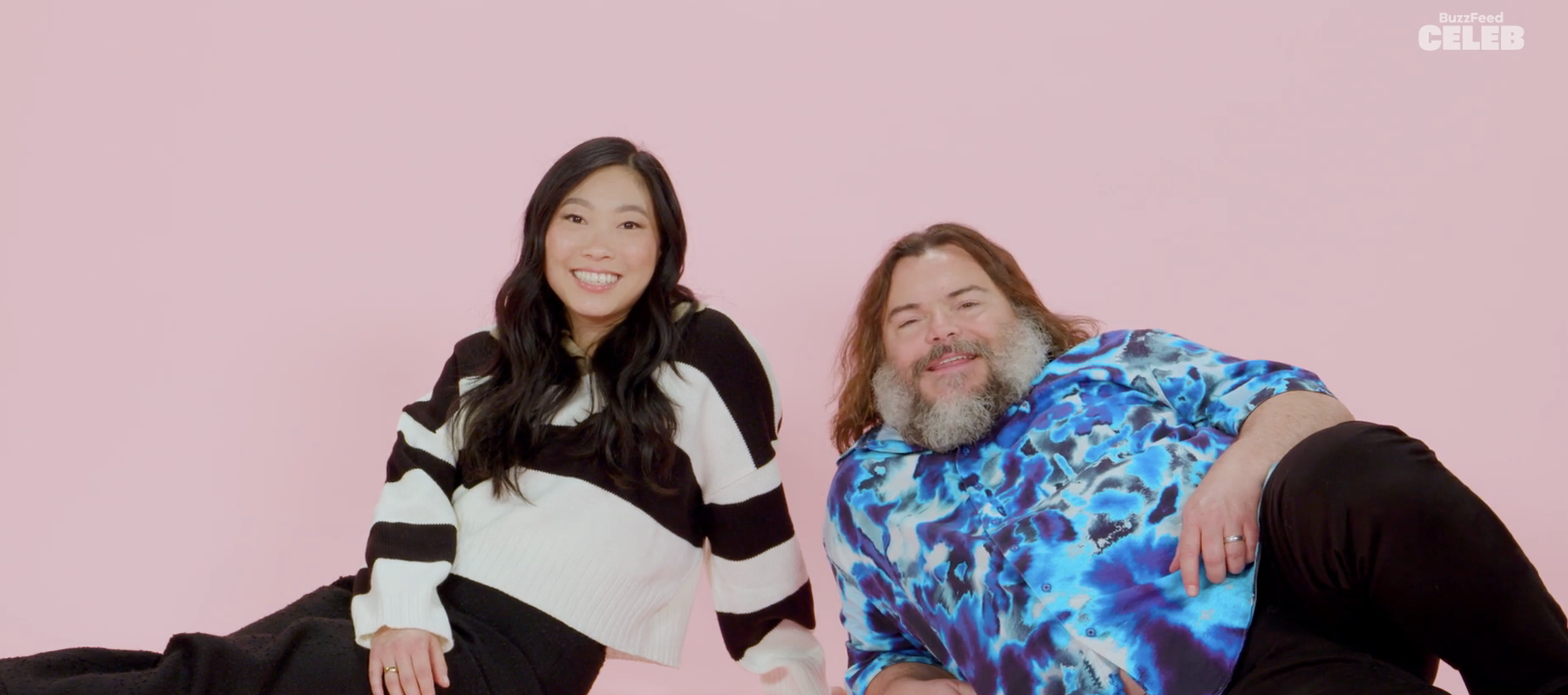 Closeup of Awkwafina and Jack Black sitting on the ground
