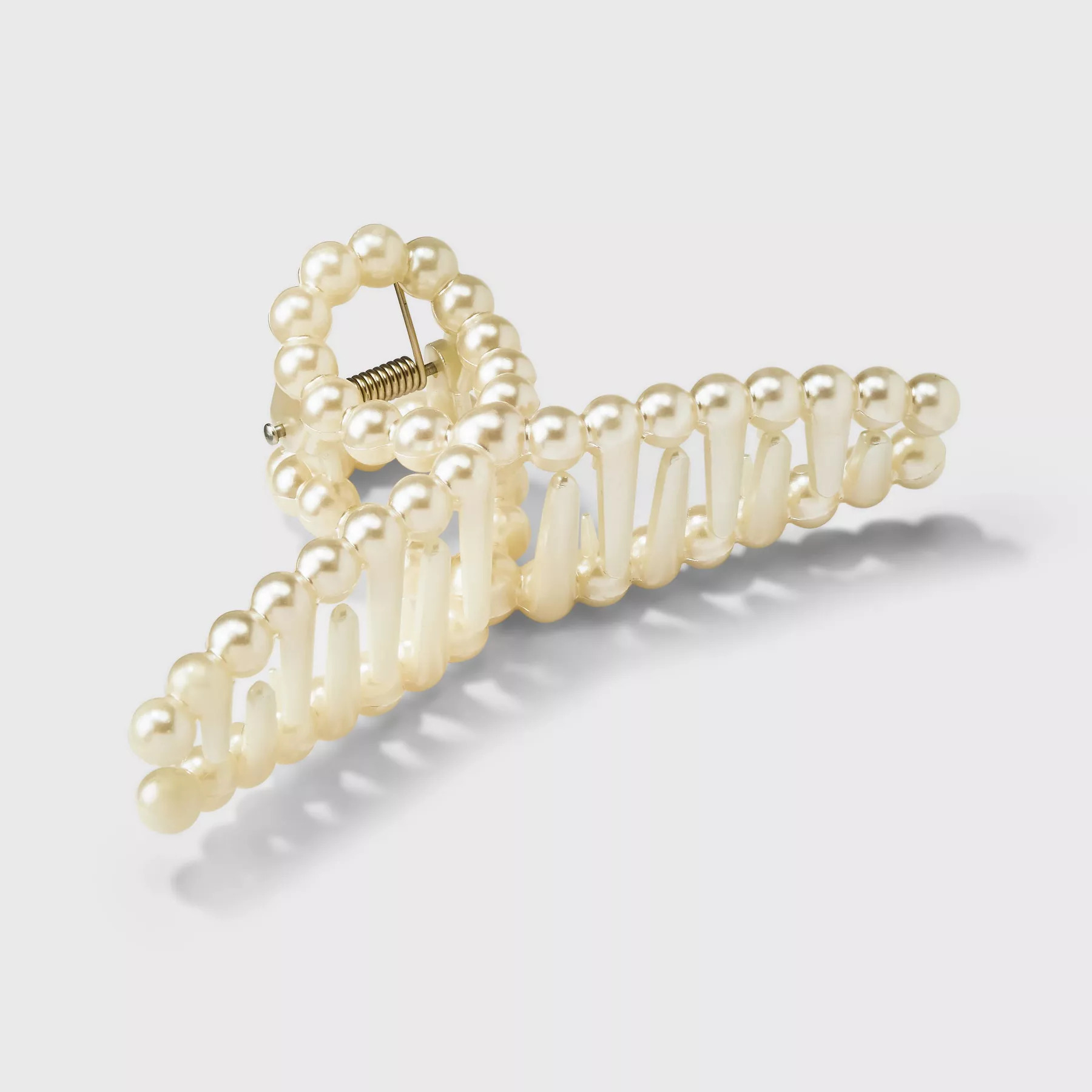 The hair clip in a champagne gold color and loop design