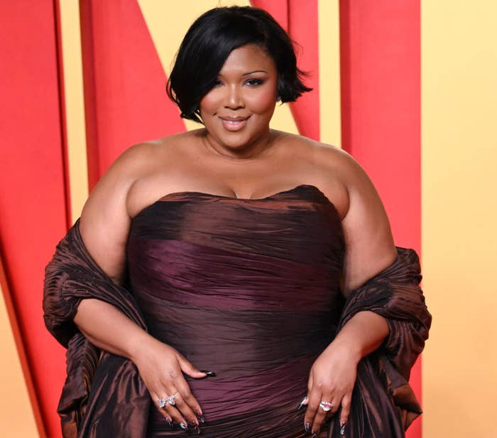 Lizzo on red carpet in a strapless, ruched gown