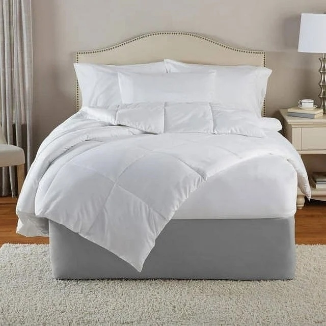 White bedding set on a bed in a neutral-toned room, aimed for a serene bedroom look