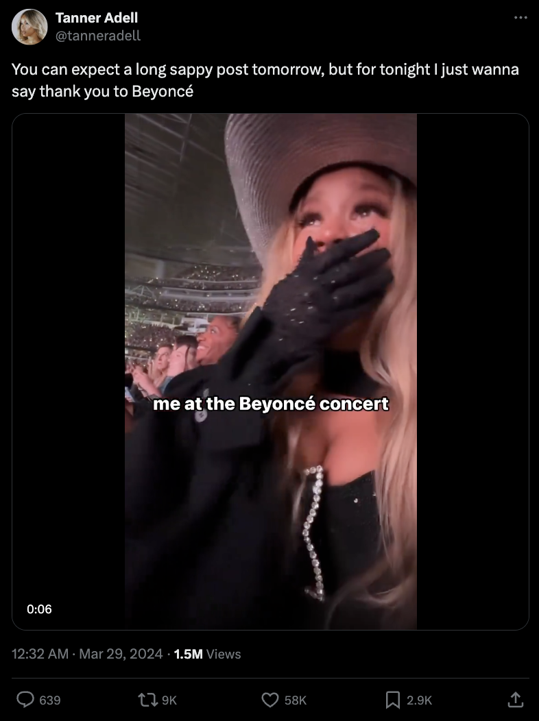 Fan in a hat and gloves reacts emotionally at a Beyoncé concert