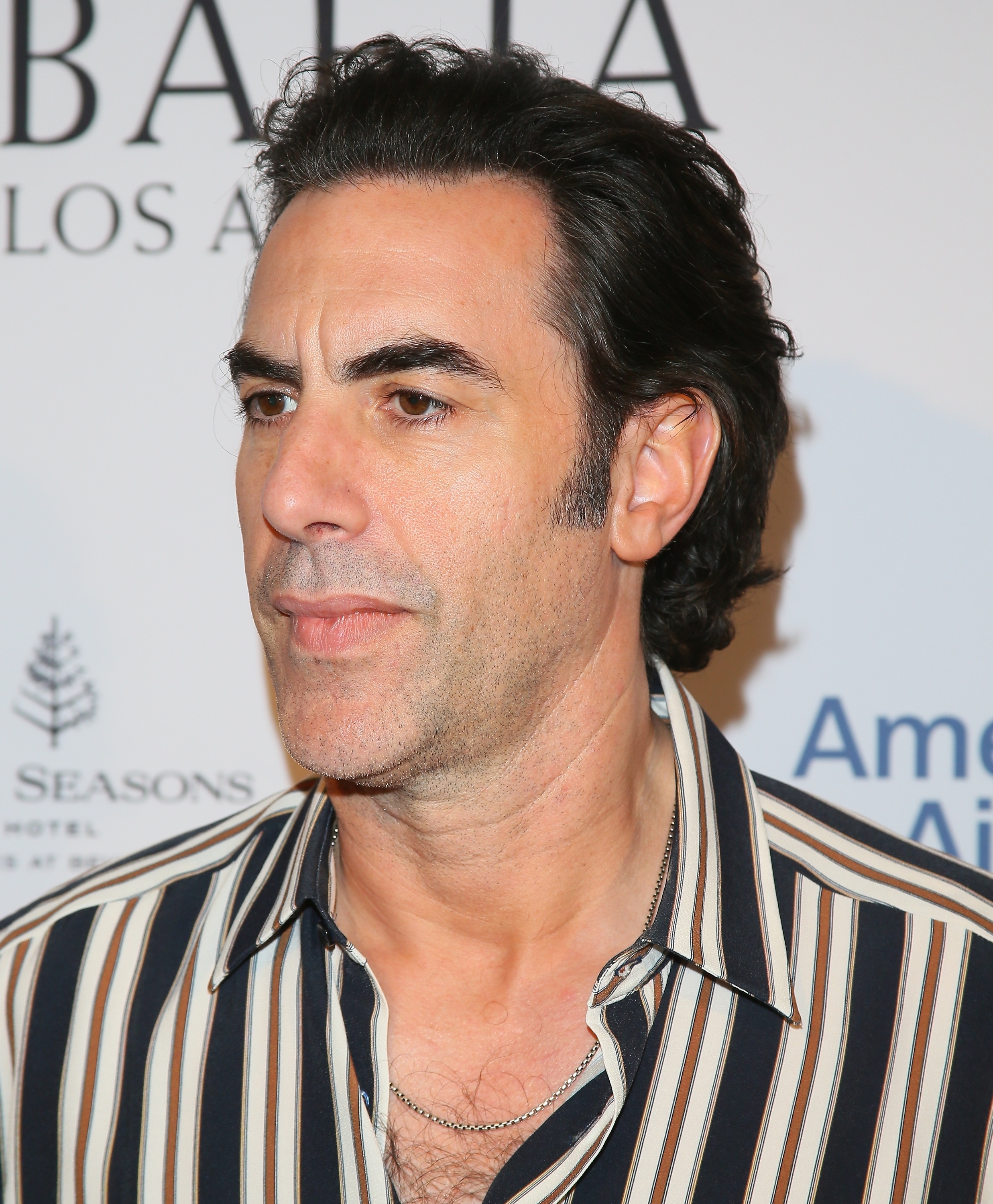Man in a striped shirt posing at an event