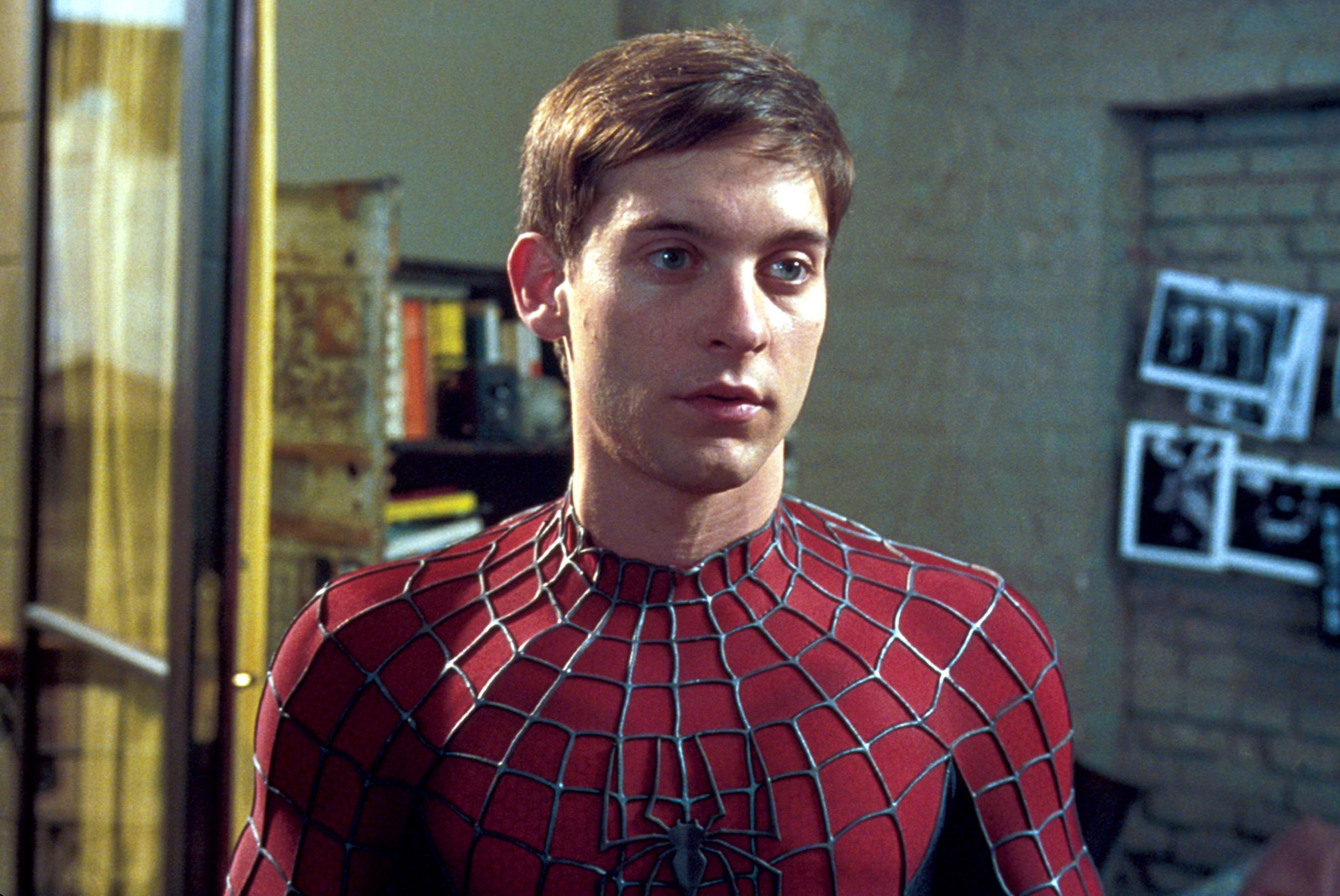 Peter Parker in Spider-Man suit without the mask, looking concerned