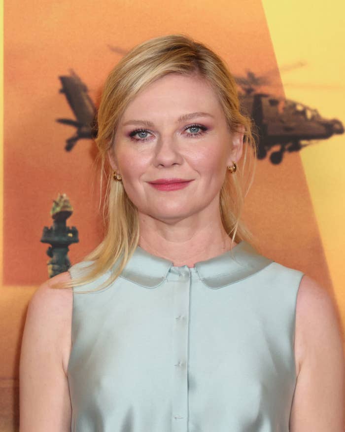Kirsten Dunst at an event wearing a sleeveless blouse with a button-up collar