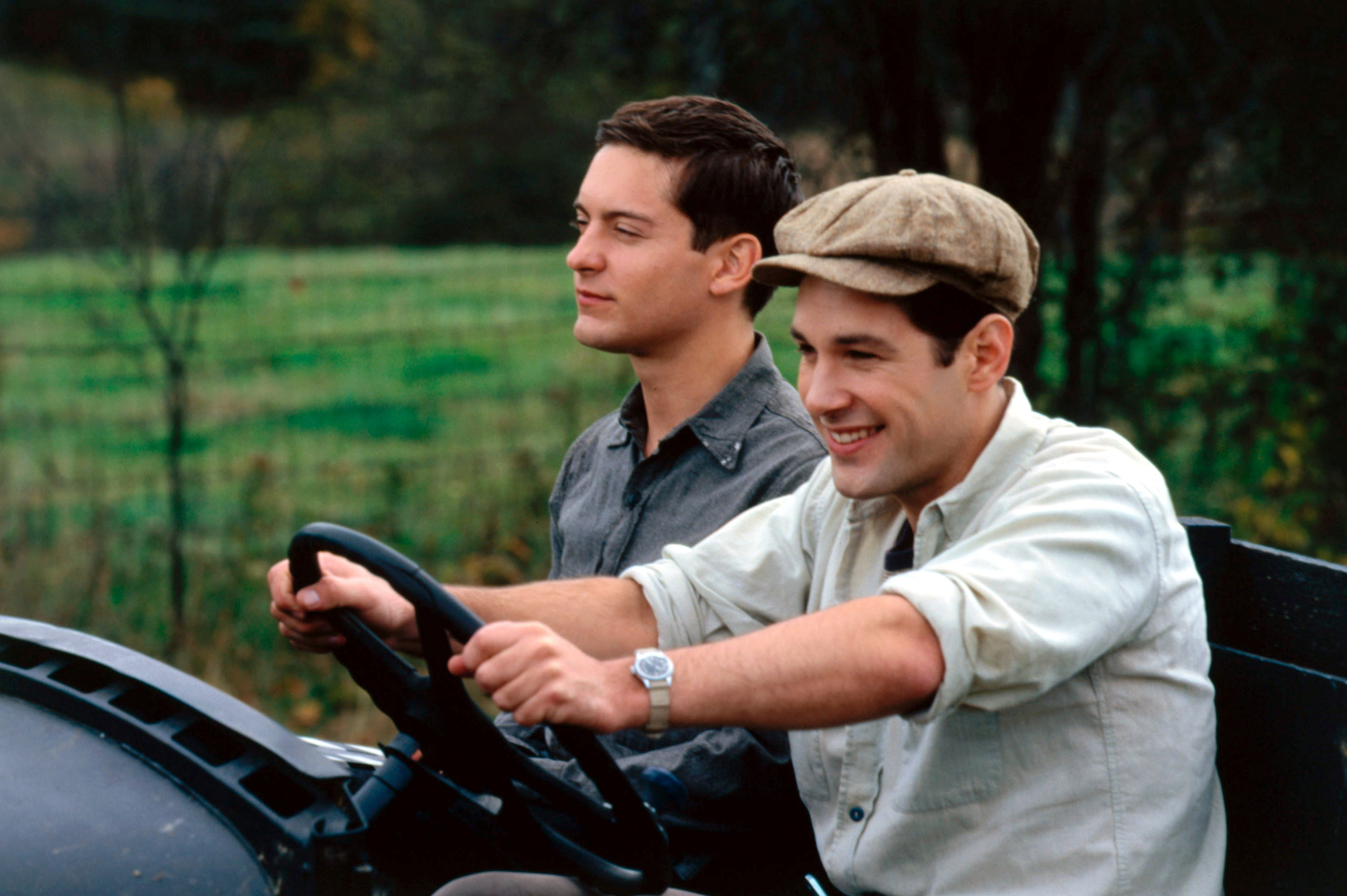 Tobey Maguire and another man in a vintage car in the Cider House Rules