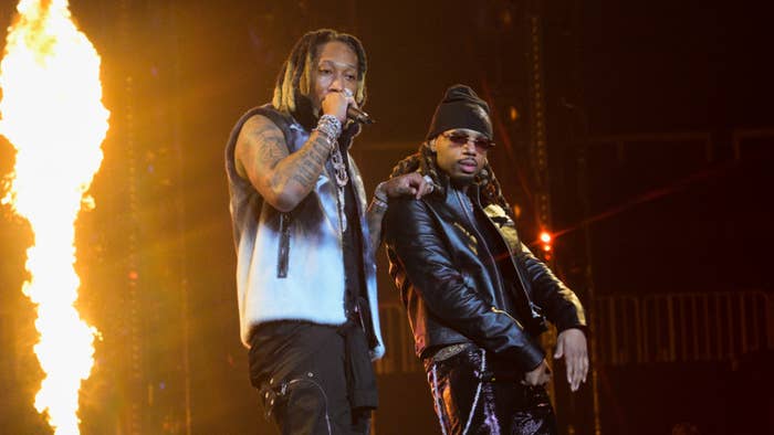 Future and Metro Boomin on stage performing with pyrotechnics in the background
