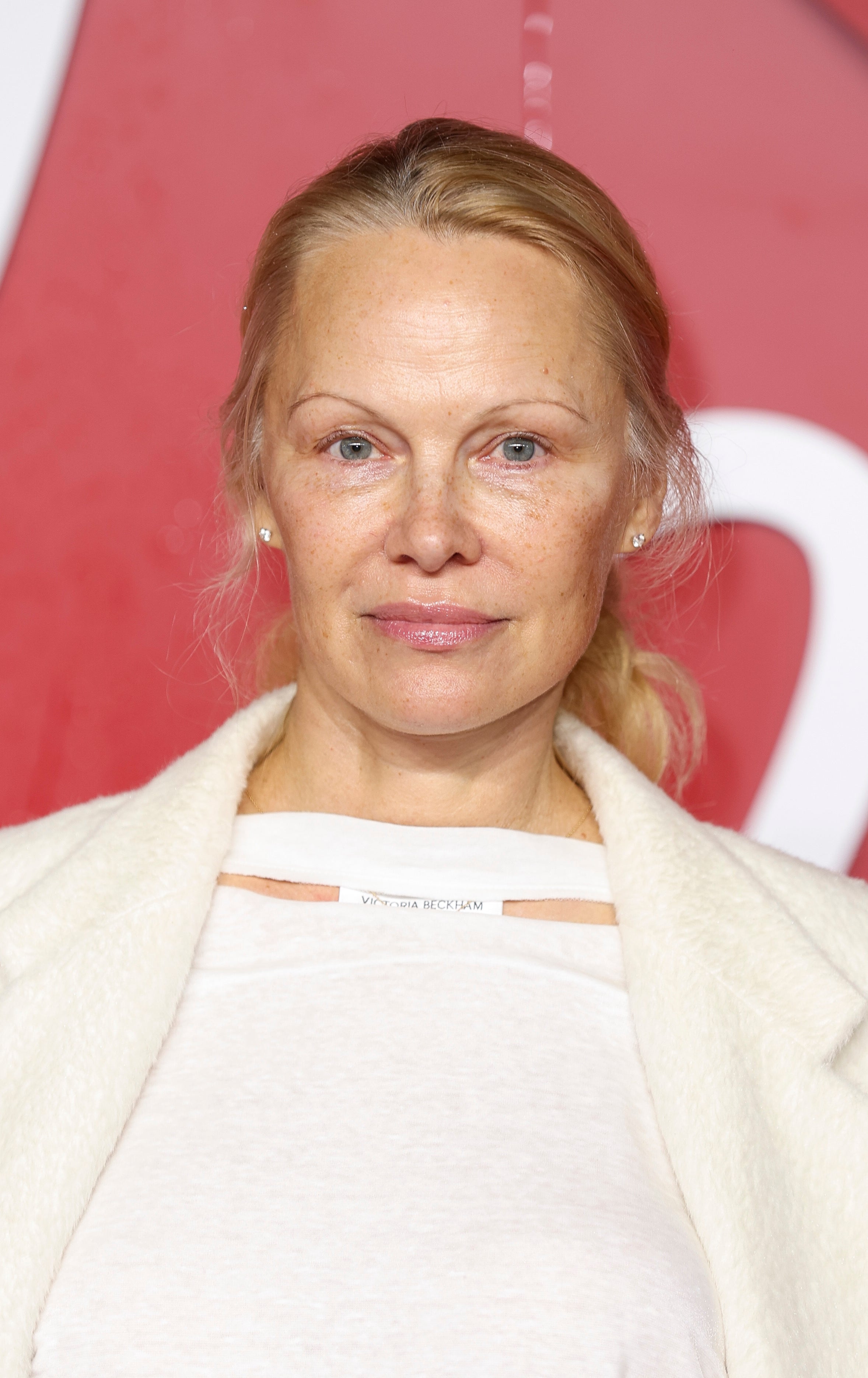 Close-up of Pamela sans makeup at a media event