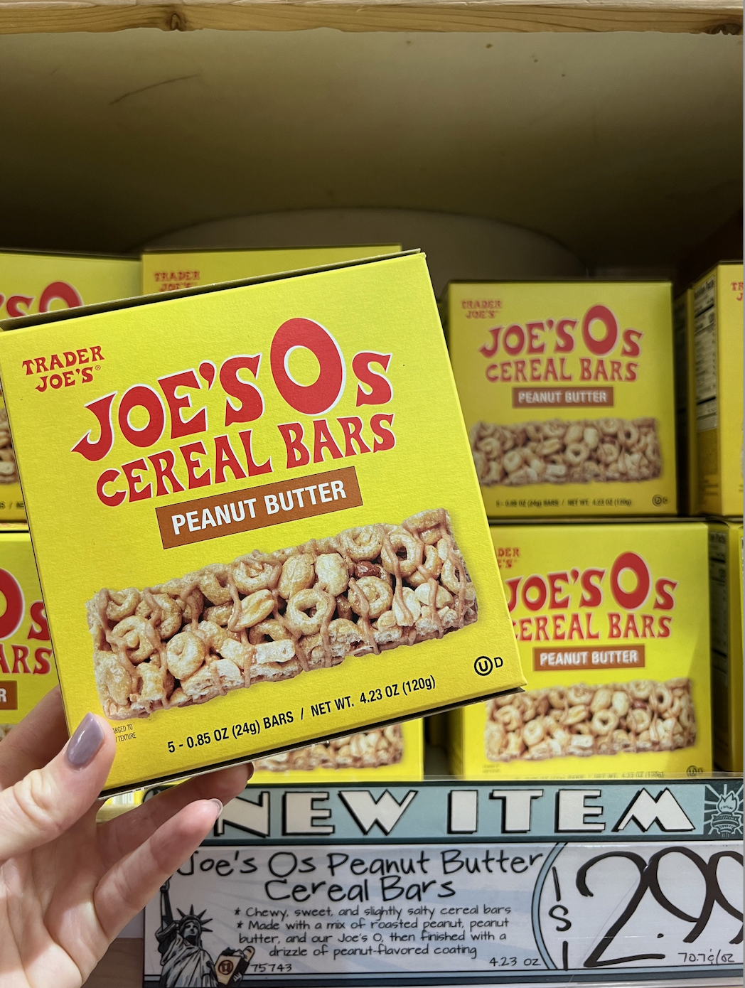 Hand holding a box of Joe&#x27;s O&#x27;s Peanut Butter Cereal Bars at a store with price tag shown
