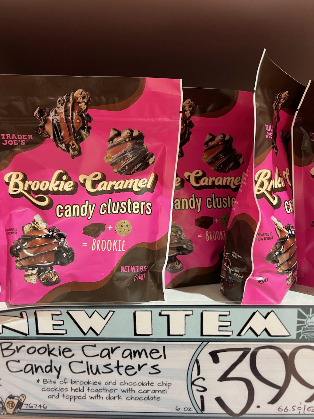 New item on shelf, &quot;Brookie Caramel Candy Clusters,&quot; chocolate treats with packaging featuring dessert images; price tag below reads &quot;$3.99&quot;