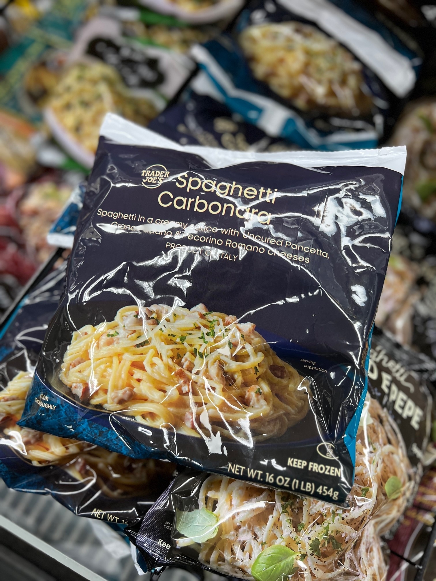 Package of Trader Joe&#x27;s Spaghetti Carbonara in a freezer with various frozen foods in the background