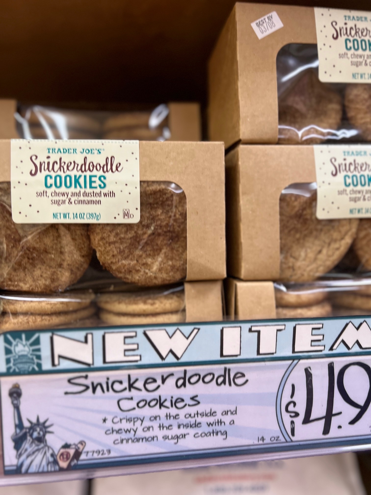 Shelves stocked with Trader Joe&#x27;s Snickerdoodle Cookies, labeled as a new item, with a price tag of $4.99