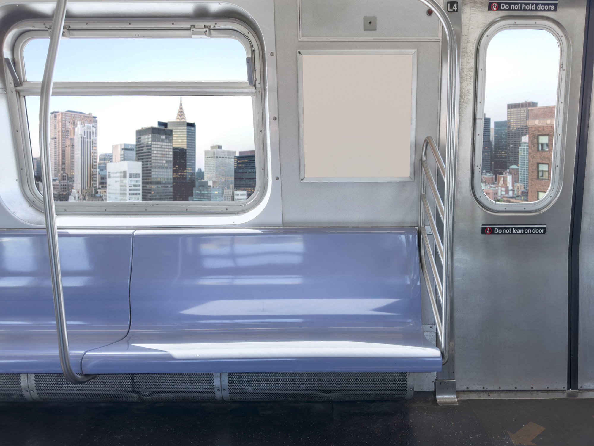 Empty subway car interior with a view of city buildings through the window