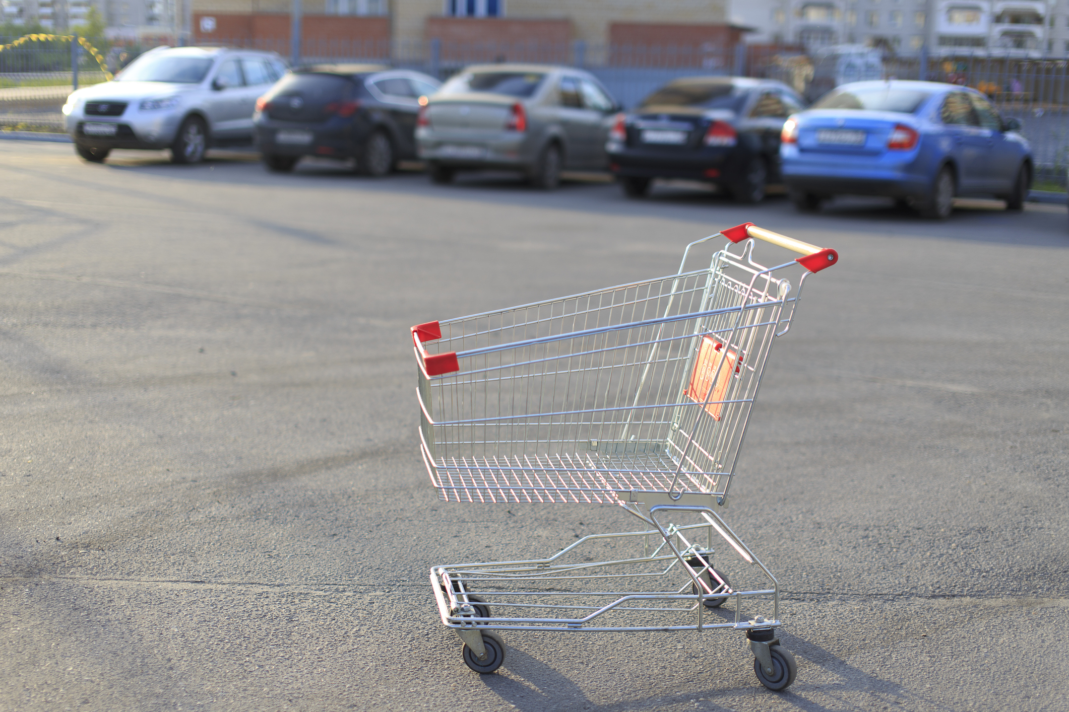 Empty shopping cart left unattended in a parking lot