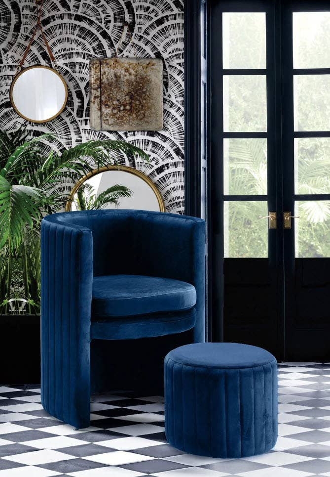 Plush blue chair and matching ottoman in a chic room with checkered floor and decorative mirrors