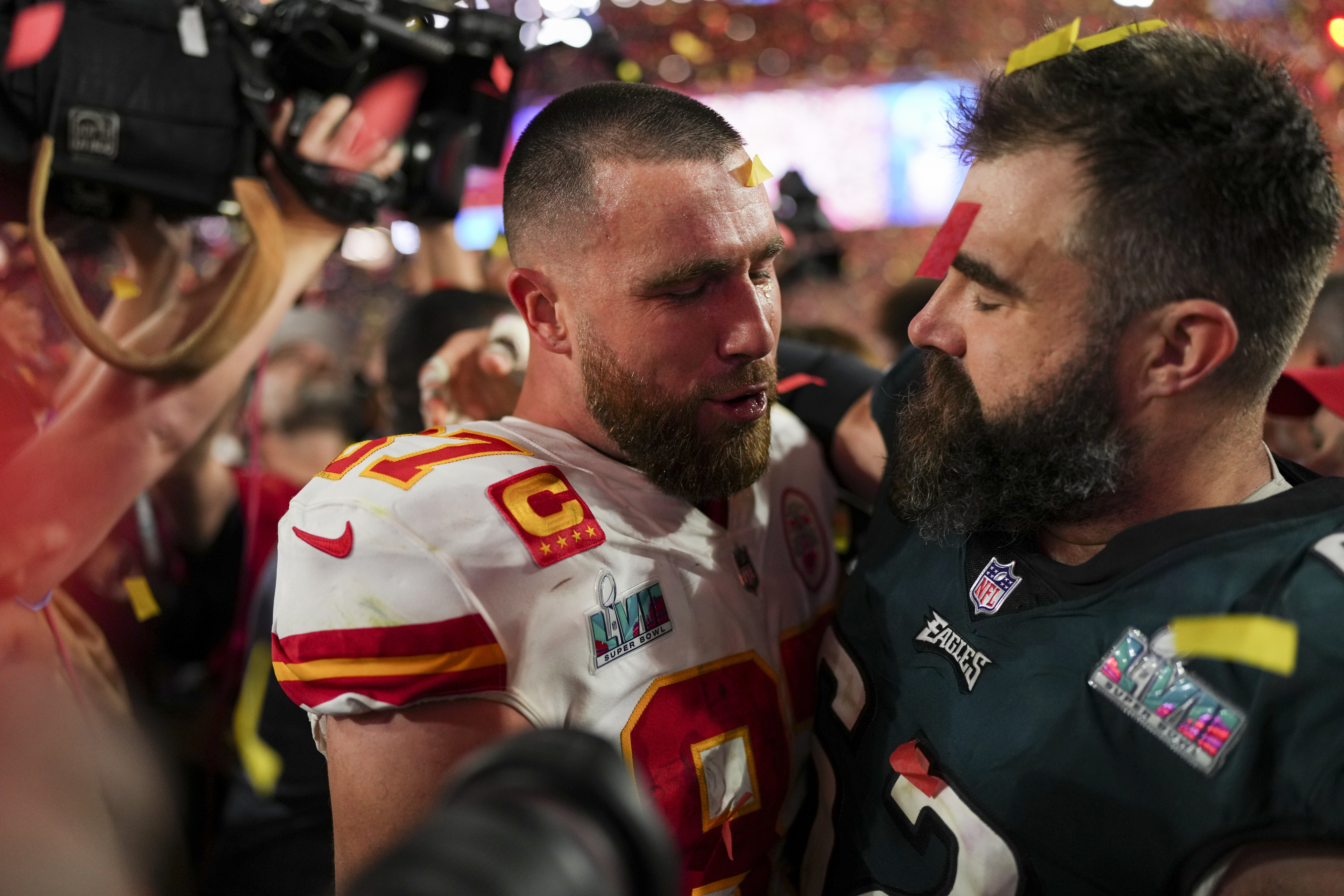 Travis and Jason Kelce embracing on the field