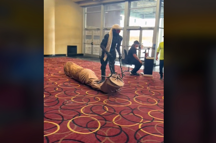 man rides worm in theater