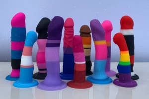 assorted stripe dildos of different sizes and colors on display and wet