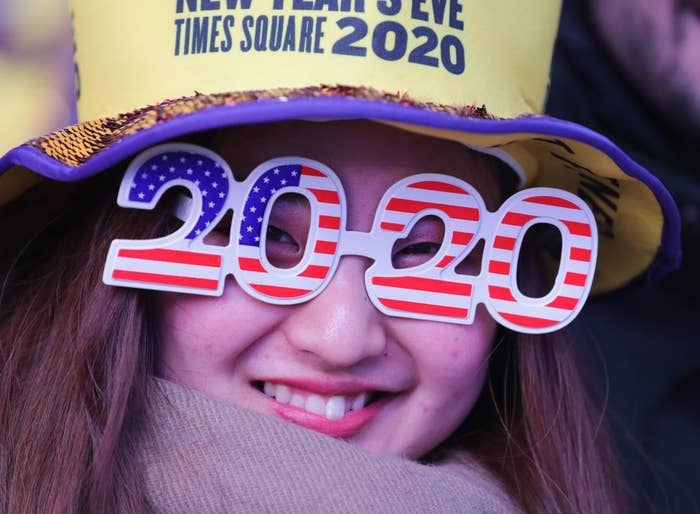 Woman wearing 2020 glasses and a New Year&#x27;s Eve Times Square hat