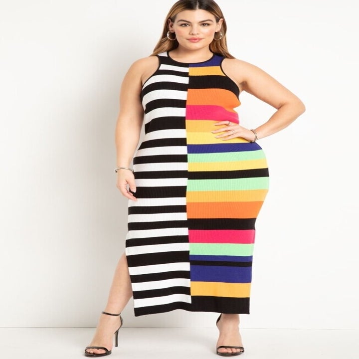Woman in a sleeveless striped dress standing, suitable for shopping category