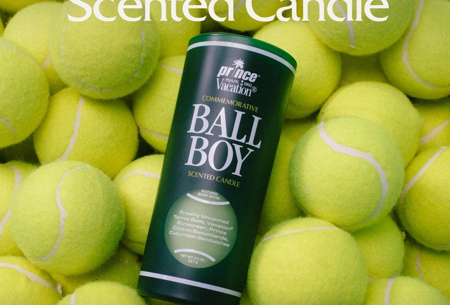 Commemorative Ball Boy scented candle by Prince Vacation, surrounded by tennis balls