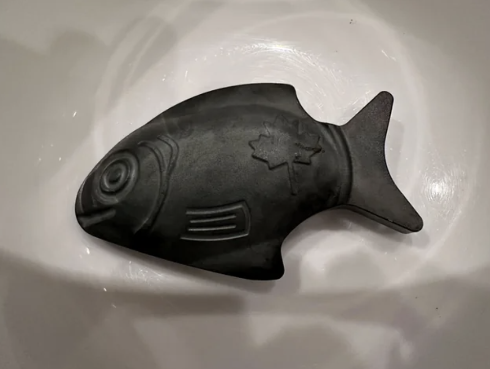 Decorative fish-shaped object in a basin