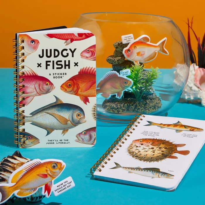 Sticker books with fish illustrations on display, one open showing stickers