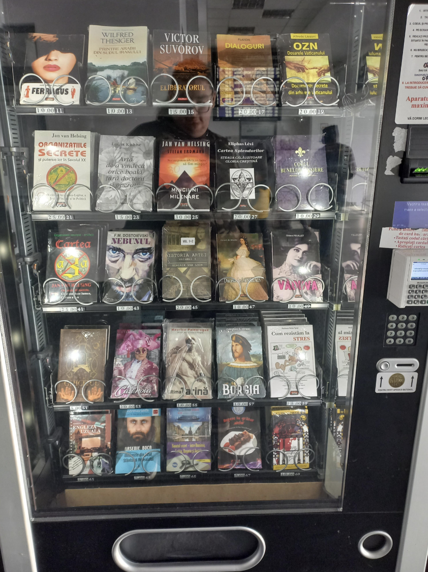 Vending machine stocked with a variety of books including fiction and biographies