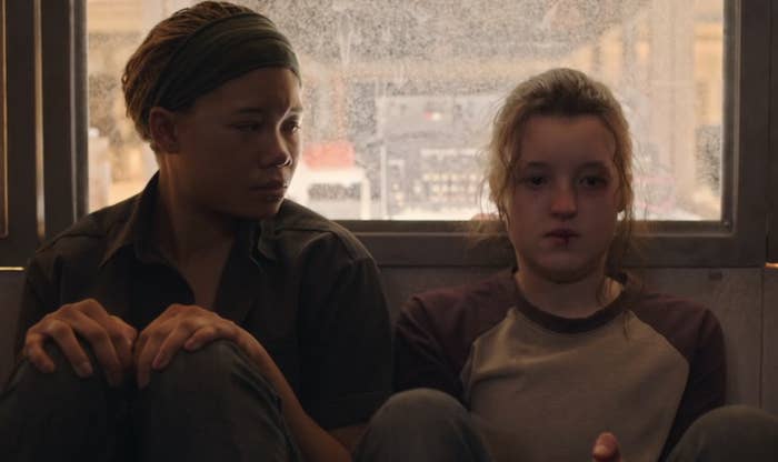 Storm Reid and Bella Ramsey sitting side by side, looking thoughtful in a scene from the show