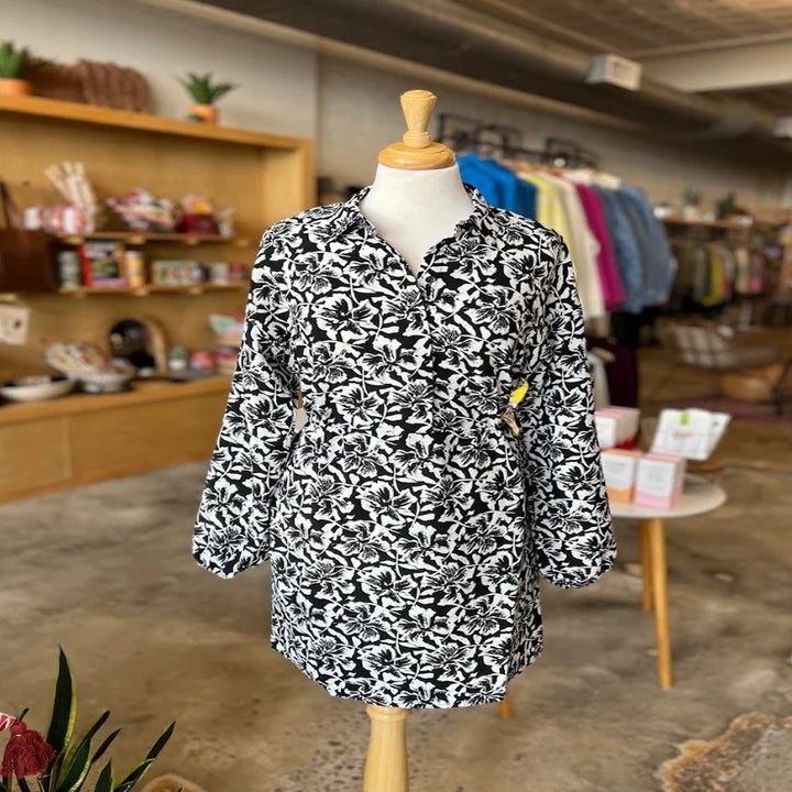 Mannequin displaying a patterned shirt dress in a boutique setting