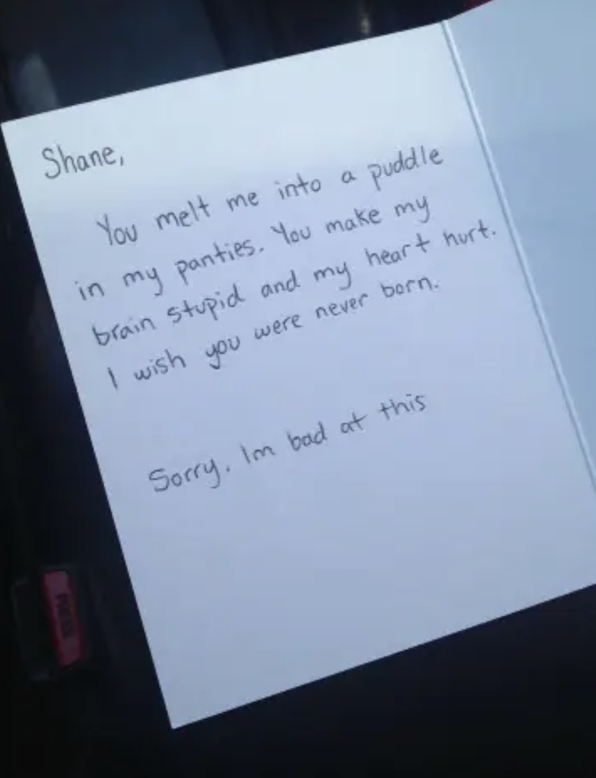 A handwritten note expressing conflicting emotions of attraction and frustration