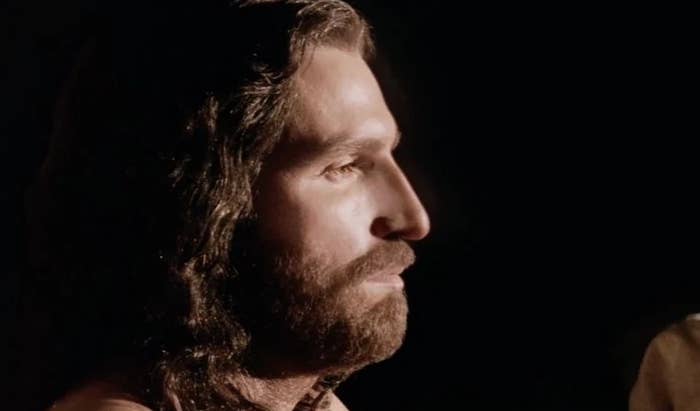 Side profile of a man with long hair and beard, in contemplative mood