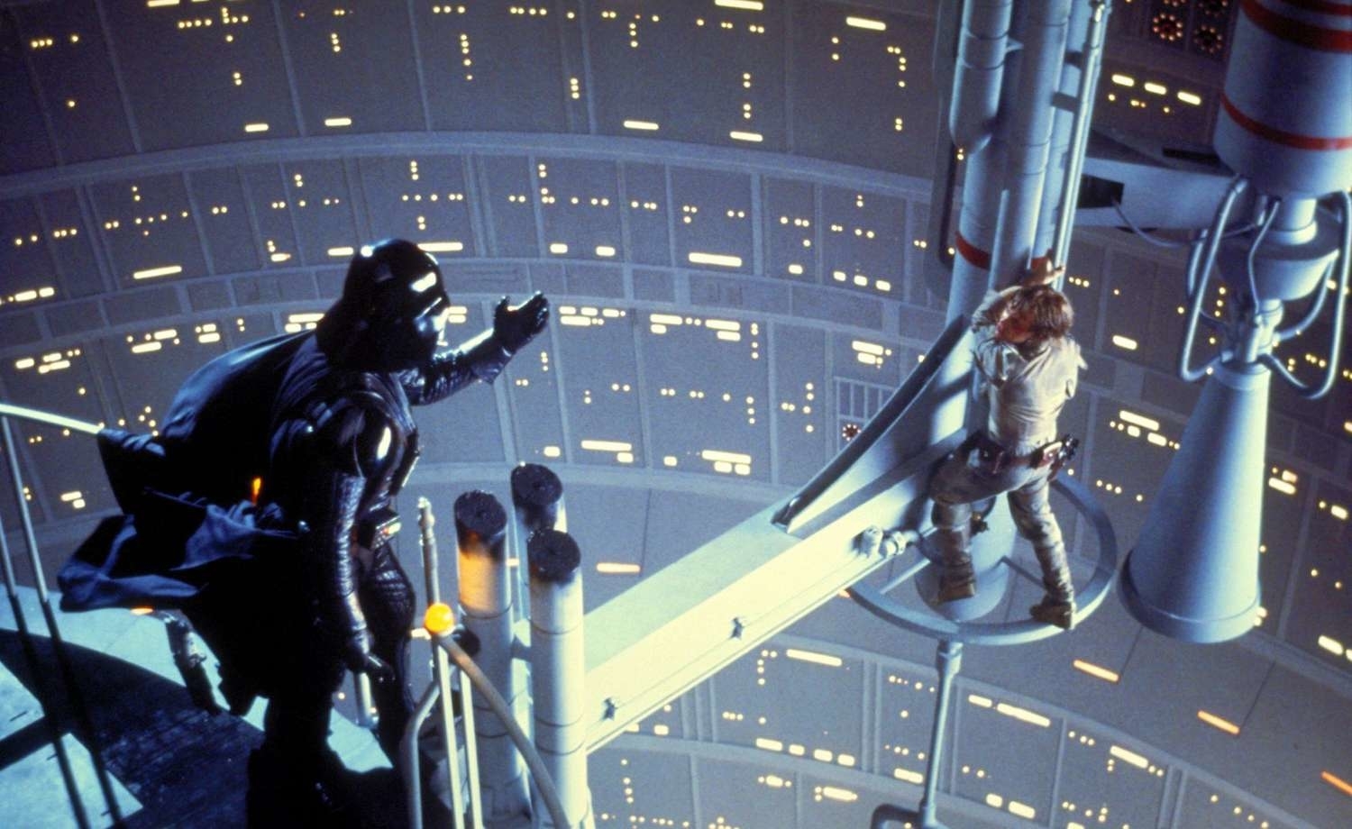 Darth Vader stands facing Luke Skywalker in a tense duel on a narrow platform