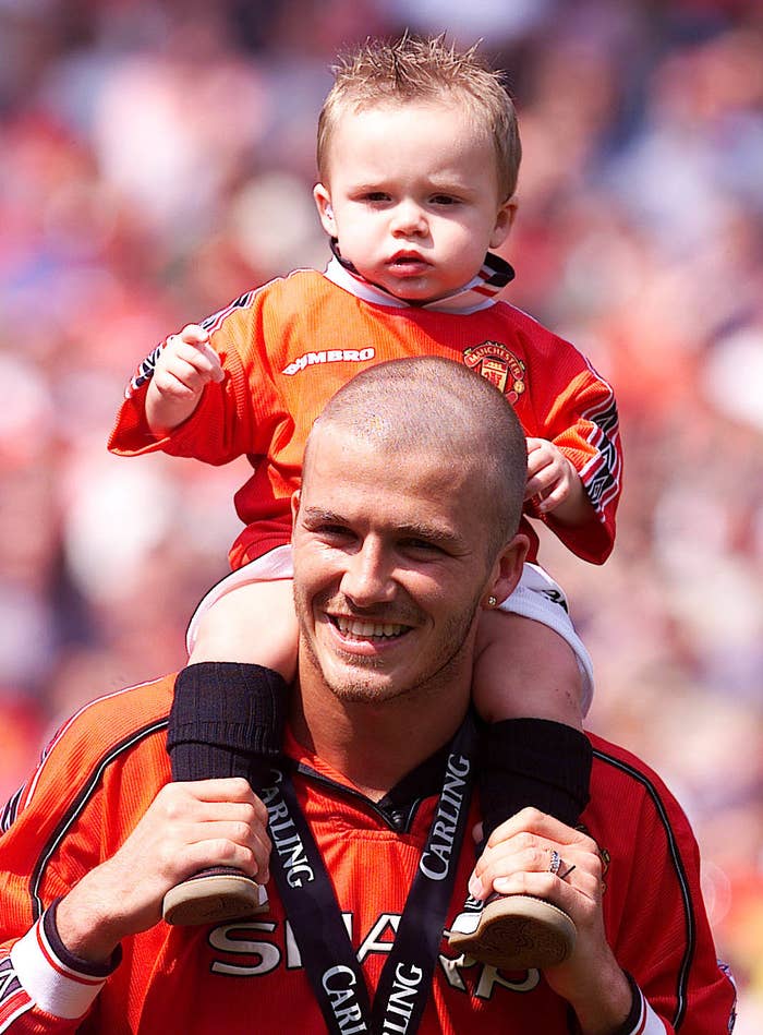 David Beckham with baby Brooklyn Beckham on his shoulders in 2002