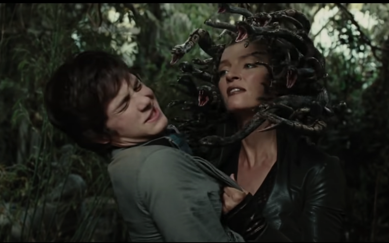 Medusa with snakes in her hair grabbing Percy Jackson