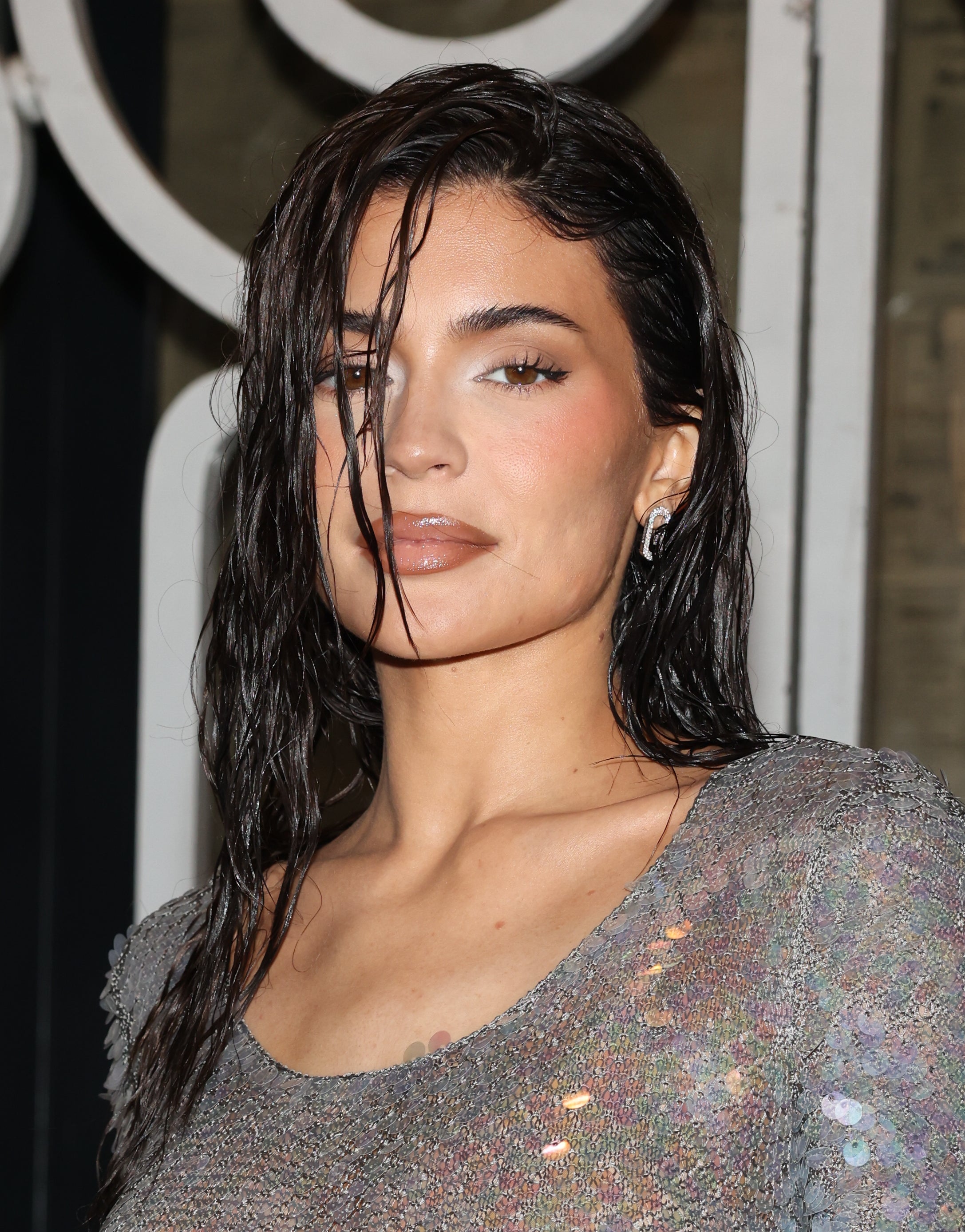 Kylie Jenner in sequined dress posing at an event